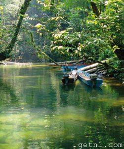 Longboats and tourists visit Clearwater Cave, Mulu National Park, in the state of Sarawak, Malaysia
